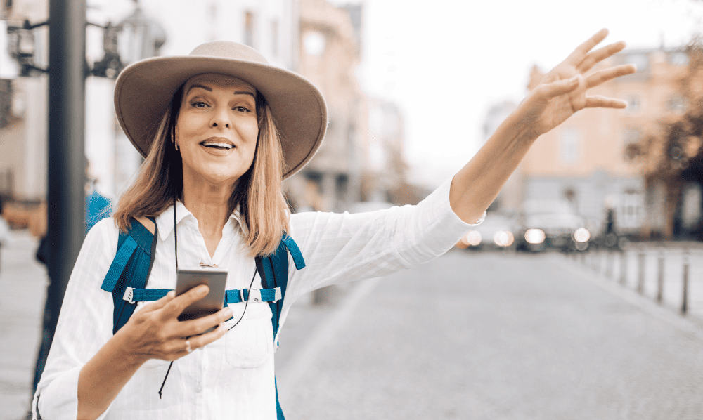 A woman waiting for car to arrive during her trip